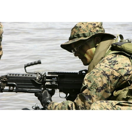 - October 10 2005 - Marine provides front security with his M-240G medium machine gun during a boat raid exercise off the coast of Guinea Poster Print