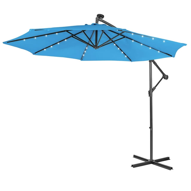 Patiojoy 10FT patio umbrella with 32 solar-powered LED lights, featuring a cantilever offset design with 8 ribs for wind resistance and adjustable angle. The blue umbrella includes a hand crank system for easy operation, ventilation design for air circulation, and a sturdy metal base. Suitable for backyards, outdoor markets, and seaside use.