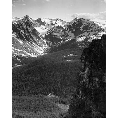 View of snow-capped mountain timbered area below in Rocky Mountain National Park Colorado ca 194 Poster Print by Ansel