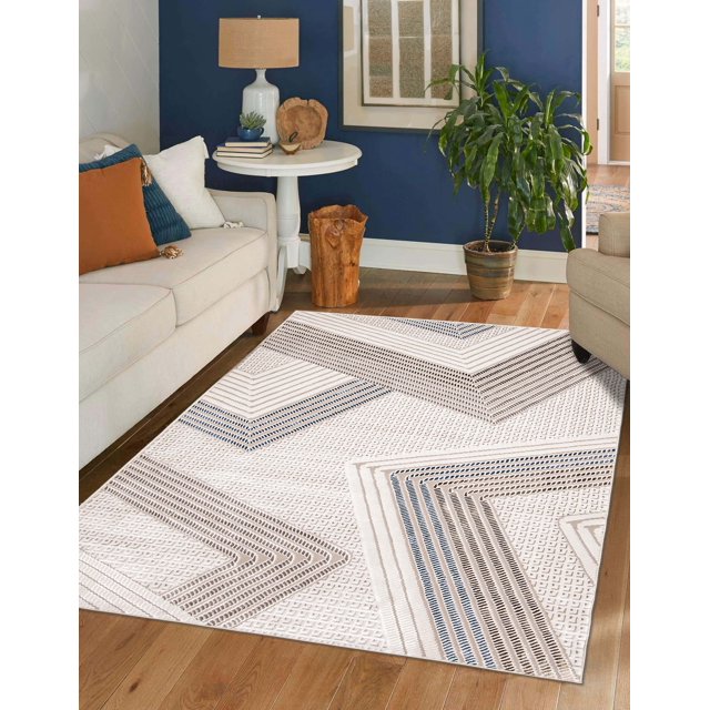 ECARPET Bentley contemporary area rug featuring beige and blue geometric designs placed on hardwood floor between sofas, complemented by modern decor including a white side table, lamp, and green plant.