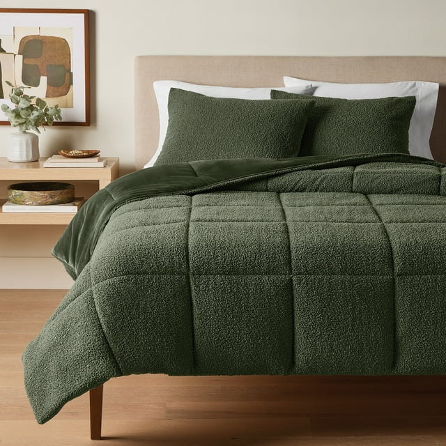 green bouclé textured comforter set with matching pillow shams on a bed in a modern bedroom setting