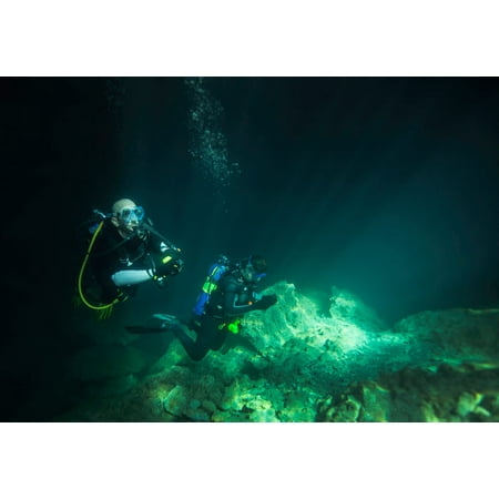 A young married couple scuba diving in Devils Den Springs Florida Poster Print by Michael WoodStocktrek