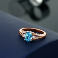 thumbnail image 4 of Gem Stone King 18K Rose Gold Plated Silver Swiss Blue Topaz and White Lab Grown Diamond 3 Stone Engagement Ring for Women | 1.58 Cttw | Oval 8X6MM | Round 2MM | Gemstone November Birthstone | Size 6, 4 of 4
