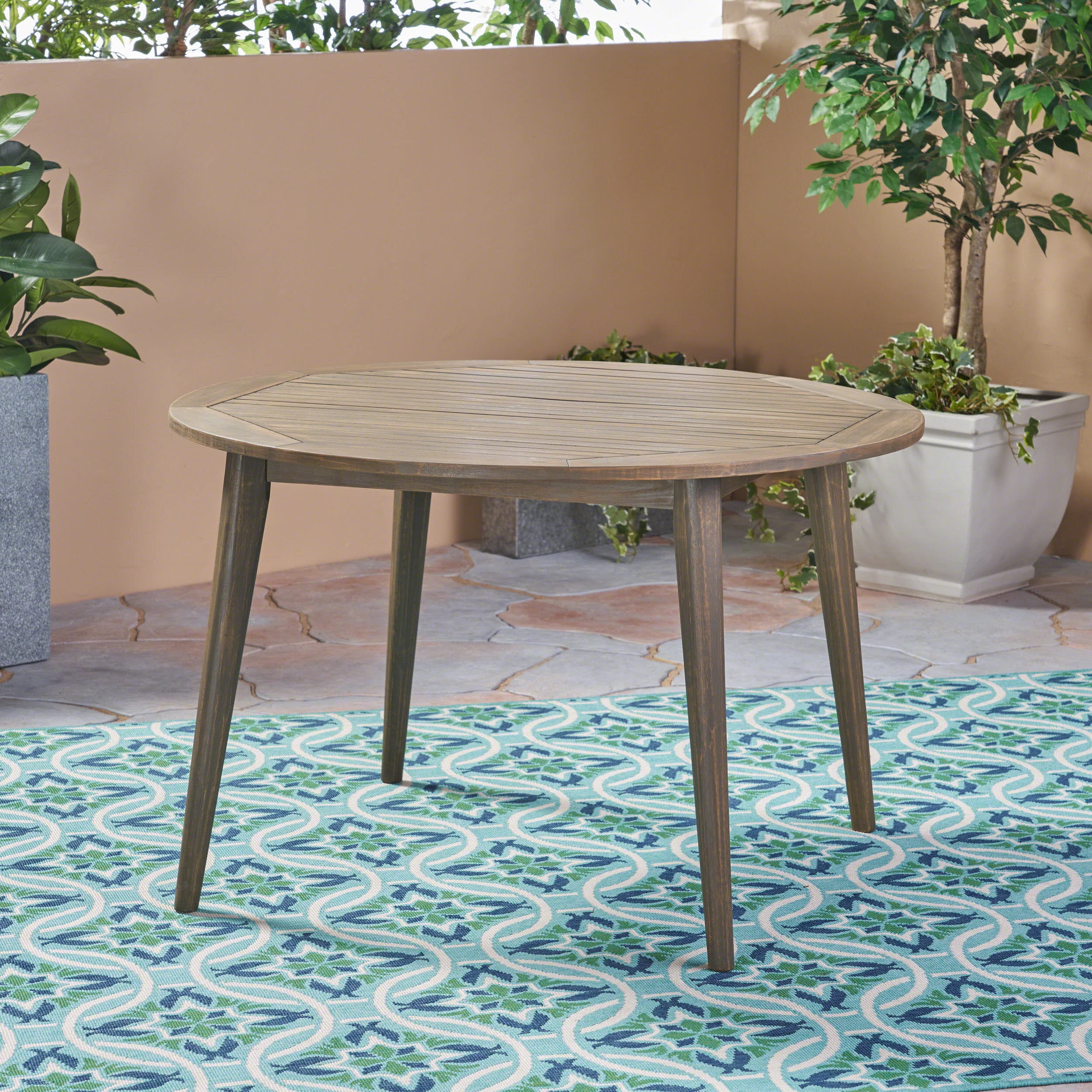 Euroco simple and sleek acacia wood dining table is the perfect addition to any backyard space