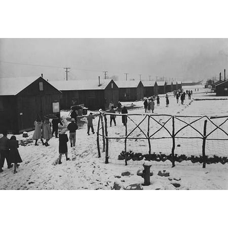 People walking through relocation center in snow past hand made wood fence  Ansel Easton Adams was an American photographer best known for his black-and-white photographs of the American West 