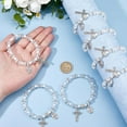 thumbnail image 3 of Pulsera de rosario elástica de 24 cuentas con bolsitas de malla, ideal para bautizo o comunión. Pulseras de conchas marinas en color concha, con crucifijo., 3 of 9