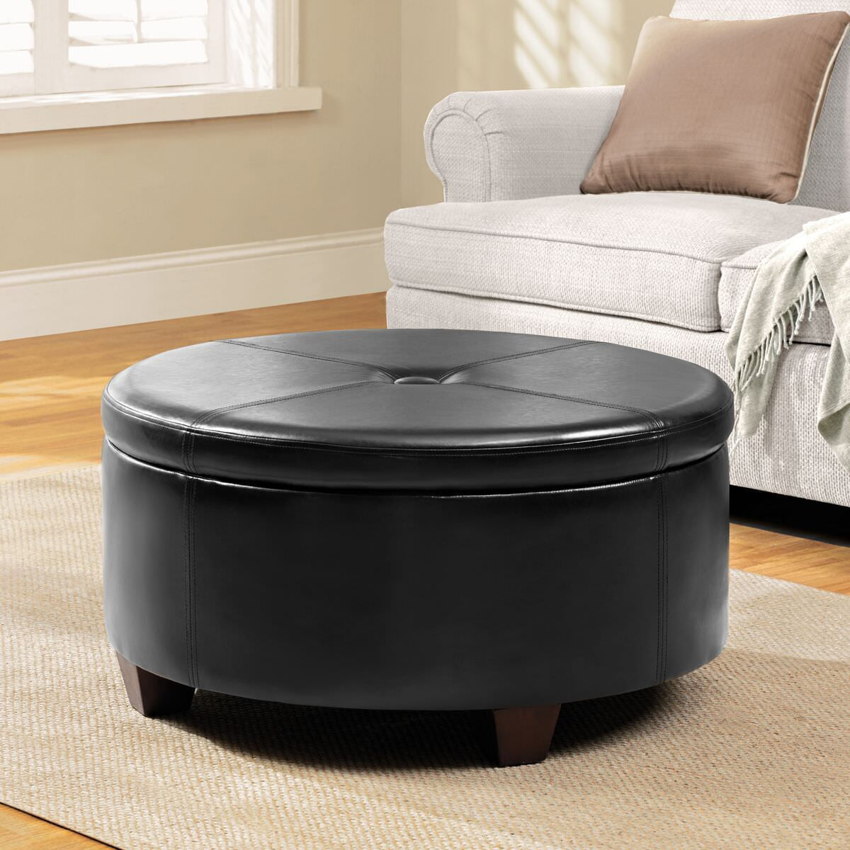 Leatherette Single Button Tufted Round Ottoman with Wooden Feet Large Black and Brown - Saltoro Sherpi