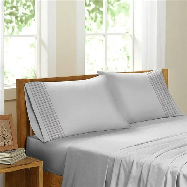 Egyptian Comfort Sateen Sheet Set, White - Queen. A luxurious white queen-size sheet set made from 100% brushed microfiber, featuring a silky soft texture, wrinkle resistance, and hypoallergenic properties. Includes a fitted sheet with 16-inch deep pockets, a flat sheet, and matching pillowcases. Displayed on a wooden bed frame in a bright, sunlit bedroom with a contemporary design.