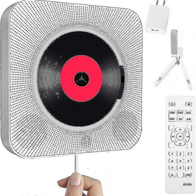reproductor de cd portátil con bluetooth, reproductor de cd de pared qoosea reproductor de CD montable en pared, vista frontal cuadrada con rejilla perforada blanca y bandeja central que muestra un CD negro con etiqueta roja; tira de encendido con tirador visible, control remoto blanco, soporte plegable y adaptador incluidos; funciones: Bluetooth, radio FM, puerto USB y entrada auxiliar 3.5 mm. Apto para sala o dormitorio y a menudo usado como altavoz Bluetooth para reproducir audio desde teléfonos.