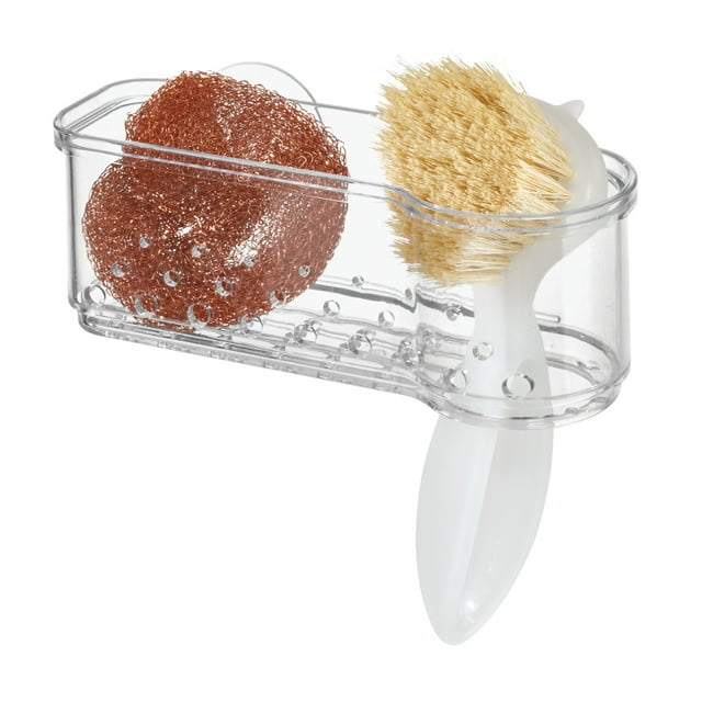 Clear plastic suction kitchen sink caddy holding a copper scrubber and white brush for organizing cleaning tools.