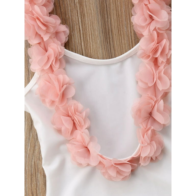 White swimsuit shop with pink flowers