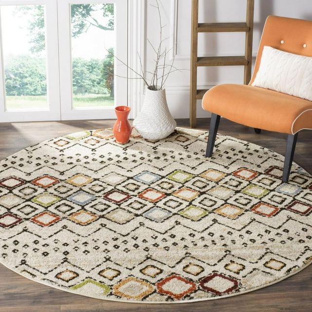SAFAVIEH Amsterdam Gladwin round area rug featuring multicolored geometric diamond patterns on a cream background, styled with an orange chair and decorative vases.