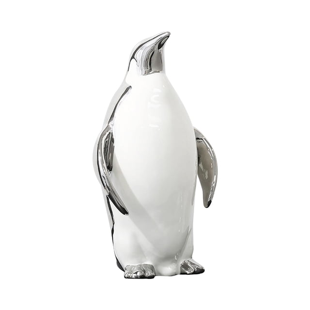 estatua de pingüino para decoración del hogar figura artística artesanal — vista frontal centrada de escultura de cerámica blanca con detalles color papá argenta en pico, alas y base; silueta erguida de 18 x 31 cm, acabado brillante. Ideal para mesa, estantería o escritorio y como regalo decorativo.