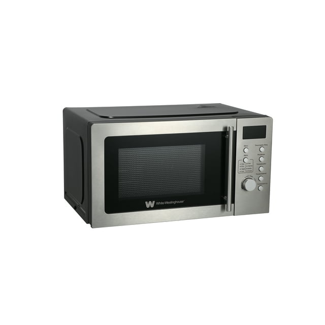 white westinghouse horno de microondas 0.7 pies modelo WWCMV0720WES plata inoxidable, vista frontal 3/4 con puerta de vidrio y asa vertical, panel derecho con display LED, perilla y botones para programas, potencia 700W, 5 niveles, plato giratorio 24.5 cm, función descongelado y temporizador hasta 60 min; compacto, ideal para departamentos y oficinas, también apto para recalentar bebidas y comidas listas.