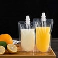 thumbnail image 2 of 50 bolsas de bebidas contenedor de bolsa de batido transparente bolsa de bebida de mano resistente a prueba de fugas y sellable 8.4 oz para botellas de bebidas de jugo congelado un embudo de plástico, 2 of 6
