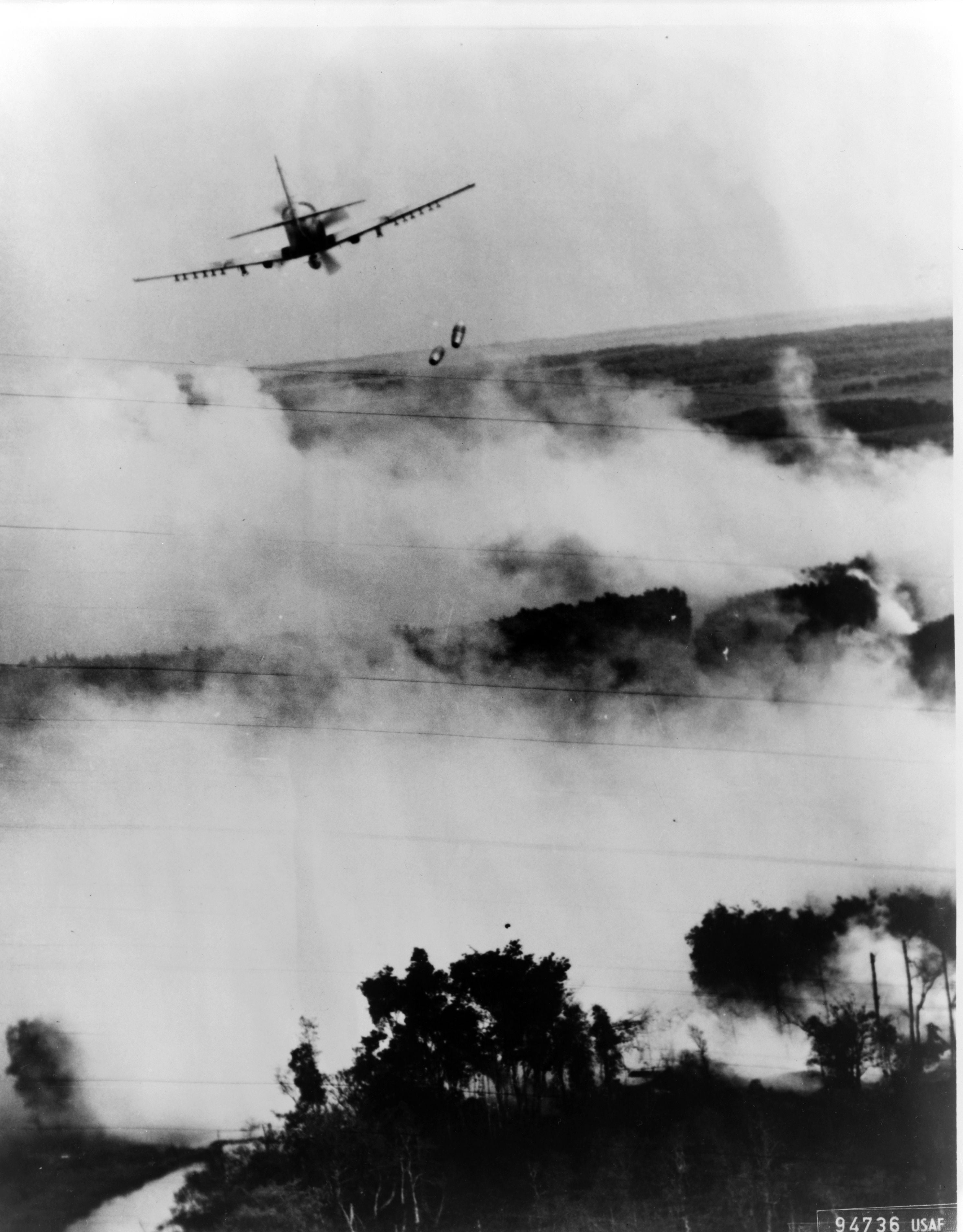 LAMINATED POSTER Two napalm bombs tumble from a Vietnamese Air Force A