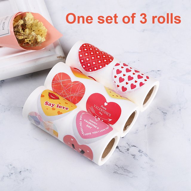 Adhesivos de papel en forma de corazón con mensajes románticos, ideales para San Valentín. Incluye 3 rollos para decorar regalos y expresar amor.