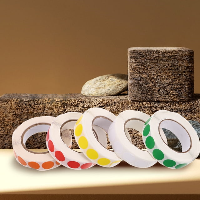 LIFKOME Self Adhesive Round Colored Dot Stickers Blank Labels for Inventory and Labeling. The image displays five rolls of round self-adhesive stickers in assorted colors: red, orange, yellow, green, and white. Each roll contains 1000 stickers, suitable for organizing, labeling, and inventory management. The rolls are arranged on a textured surface with a neutral-toned background.