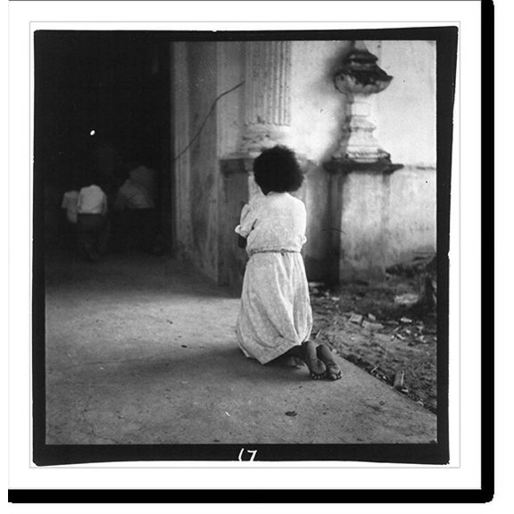 Historic Print, [Catholic religious scenes in Puerto Rico, 1944-46: child kneeling outside church doorway], 16" x 20"