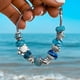 thumbnail image 3 of Pulsera de cristal azul océano con estrellas de mar y tortugas, 3 of 8