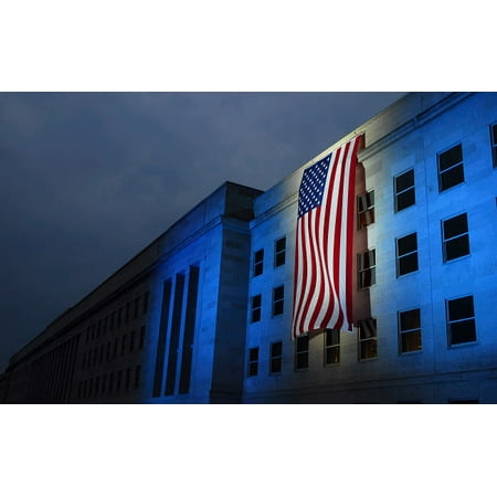 - A memorial flag is illuminated on The Pentagon Poster Print by Stocktrek Images