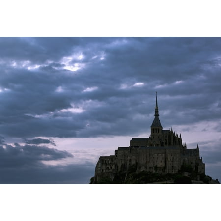 Silhouette of large stone Abbey perched on rocky hill with dramatic clouds at sunset Mont St Michel Brittany France Stretched Canvas - Michael Interisano  Design Pics (19 x