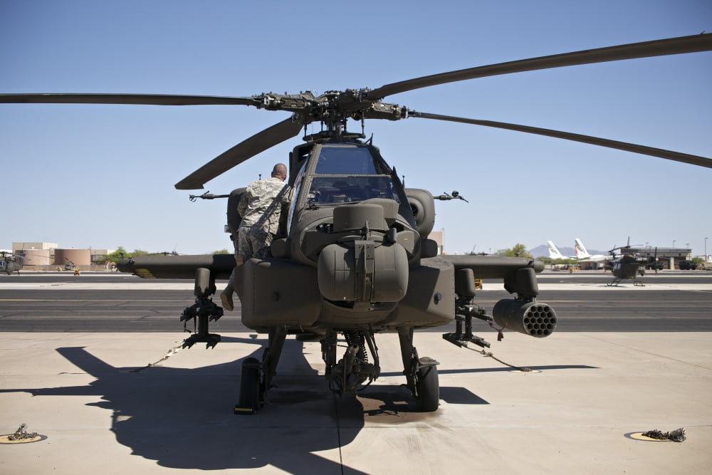 Crew chief working on an AH64D Apache Longbow helicopter at Pinal