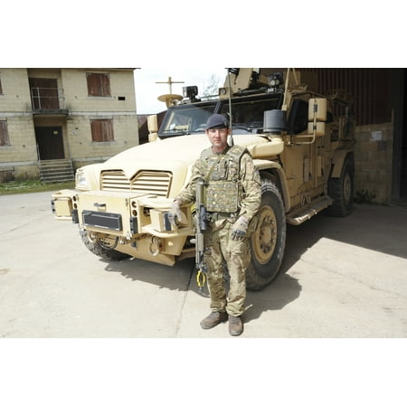 Soldier standing in front of a Husky TSV armored vehicle of the British Army Canvas Art - Andrew ChittockStocktrek Images (17 x 12)