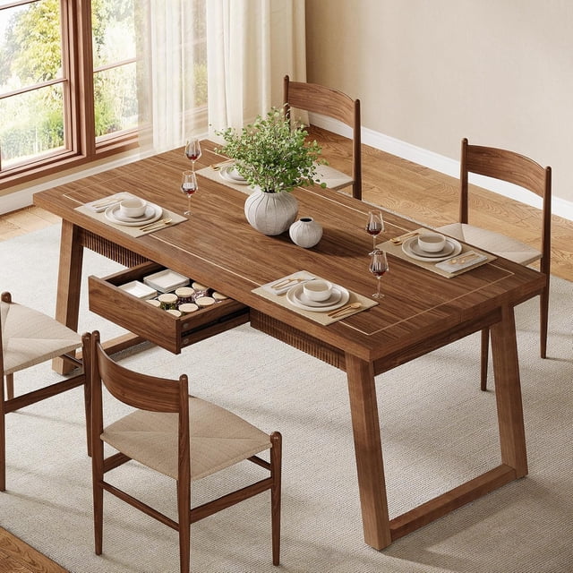 55'' Rectangular Dinner Kitchen Table with a mid-century modern design, featuring a walnut finish and solid wood legs. The table includes a hidden storage drawer for cutlery and small essentials, and its 55'' x 27.6'' surface comfortably seats 4 to 6 people. Shown in a dining room setting with four matching chairs, tableware, and decorative vases.