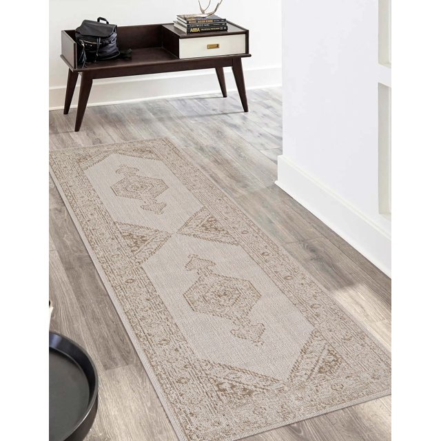 ECARPET Maude traditional runner rug featuring beige and brown geometric designs, placed on light wood flooring in an entryway with mid-century modern furniture.
