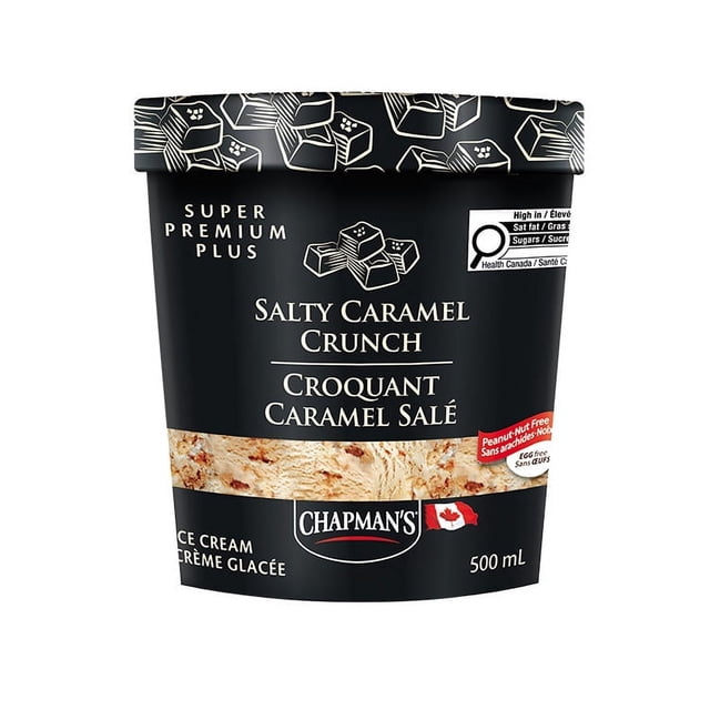 Chapman's Super Premium Plus Salty Caramel Crunch Ice Cream in a 500 mL black tub with caramel candy illustrations on the lid, labeled peanut and nut free, egg free, kosher, made with 100% Canadian dairy, featuring caramel sauce ripple and toffee pieces, suitable as a rich frozen dessert treat.