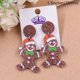 thumbnail image 1 of Pendientes colgantes de pan de jengibre Gorro navideño de Papá Noel Pendientes navideños Pendientes acrílicos, 1 of 4