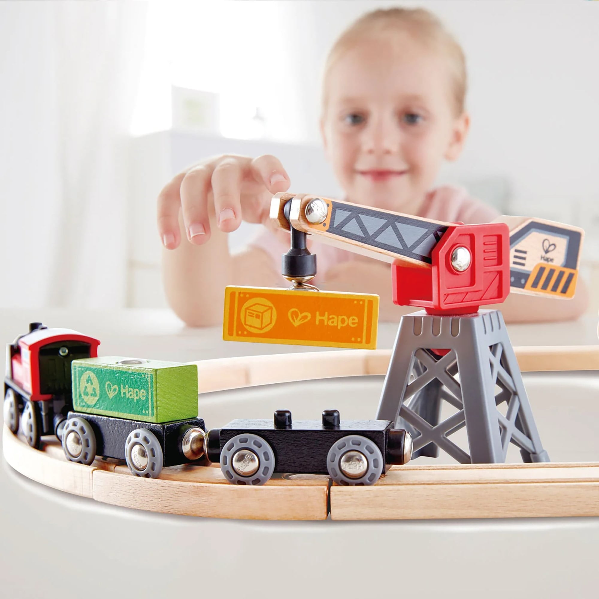 Hape: Cargo Delivery Loop - Battery Powered Engine, Oval Track Railway Set, Wooden Toy, 3 Magnetic Linking Trains, Crane, Accessories, Kids Ages 3+