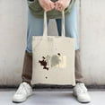 thumbnail image 2 of Stylish canvas tote bag with bold ' YOU ' in gray and white splatter design on a light beige background perfect for shopping and travel, 2 of 4