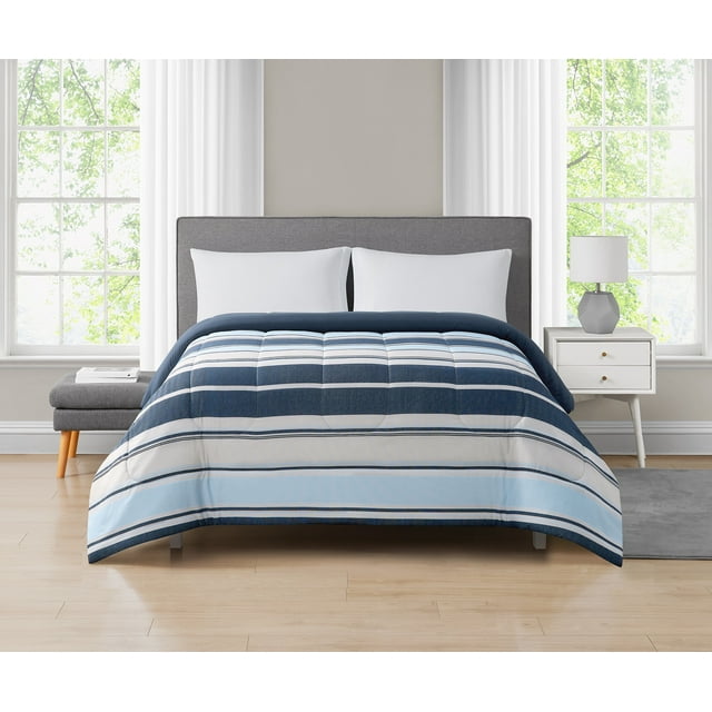 Mainstays Stripe Reversible Comforter in blue, white, and beige stripes on a twin bed with gray headboard in bright bedroom.