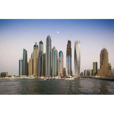 UAE, Dubai Marina high-rise buildings including the twisted Cayan Tower, with moonrise Print Wall Art By Walter