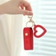 thumbnail image 2 of Llavero portátil para brillo de labios con mini pintalabios de cuero PU para viajar, pequeño y con colgante en forma de corazón y llavero, 2 of 5