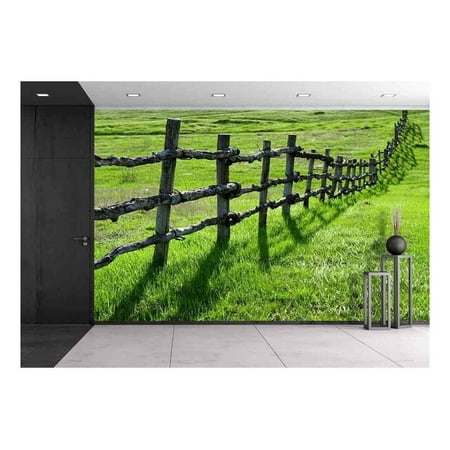 wall26 - Old Wooden Fence on Green Meadow - Removable Wall Mural | Self-adhesive Large Wallpaper - 66x96