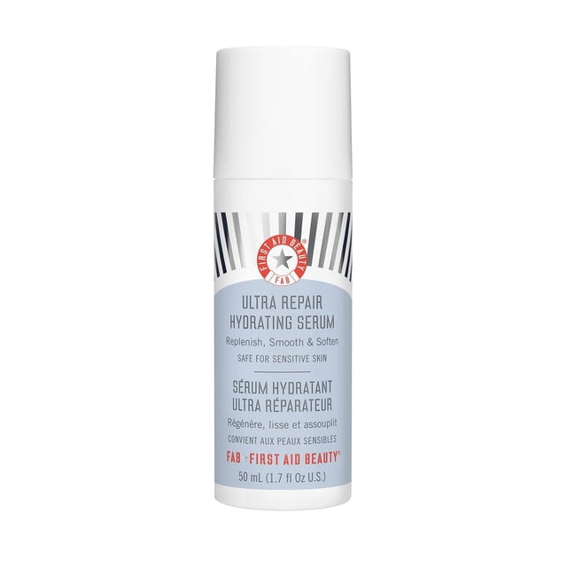 suero hidratante first aid beauty ultra reparador con ácido hialurónico para piel sensible botella cilíndrica blanca 50 ml con dispensador, etiqueta gris y azul y logo circular rojo en vista frontal; suero facial indicado para hidratación intensiva, apto para rutina diaria y piel sensible.