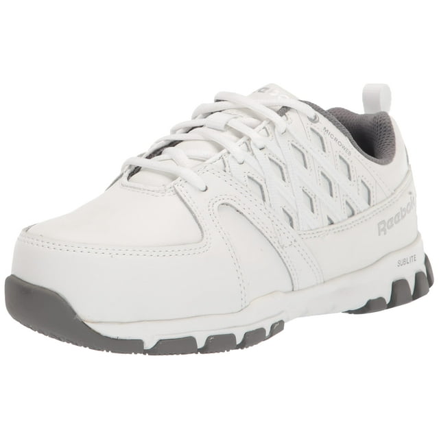 Zapato Reebok Work Sublite RB4443 con puntera de seguridad deportiva, color blanco — vista frontal 3/4 de zapatilla blanca de piel con puntera de acero que cumple ASTM F2413, cordones y paneles laterales reforzados; entresuela EVA Sublite, suela de goma antideslizante y plantilla extraíble EVA con interior acolchado gris. También suele usarse como calzado resistente para senderismo ligero o trabajo diario.