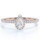 thumbnail image 1 of JeenMata Anillo Delicado con Halo de Moissanita y Piedra Lunar Arcoíris en Forma de Lágrima de 1 Quilate en Oro Rosa de 18 K sobre Plata, 1 of 6