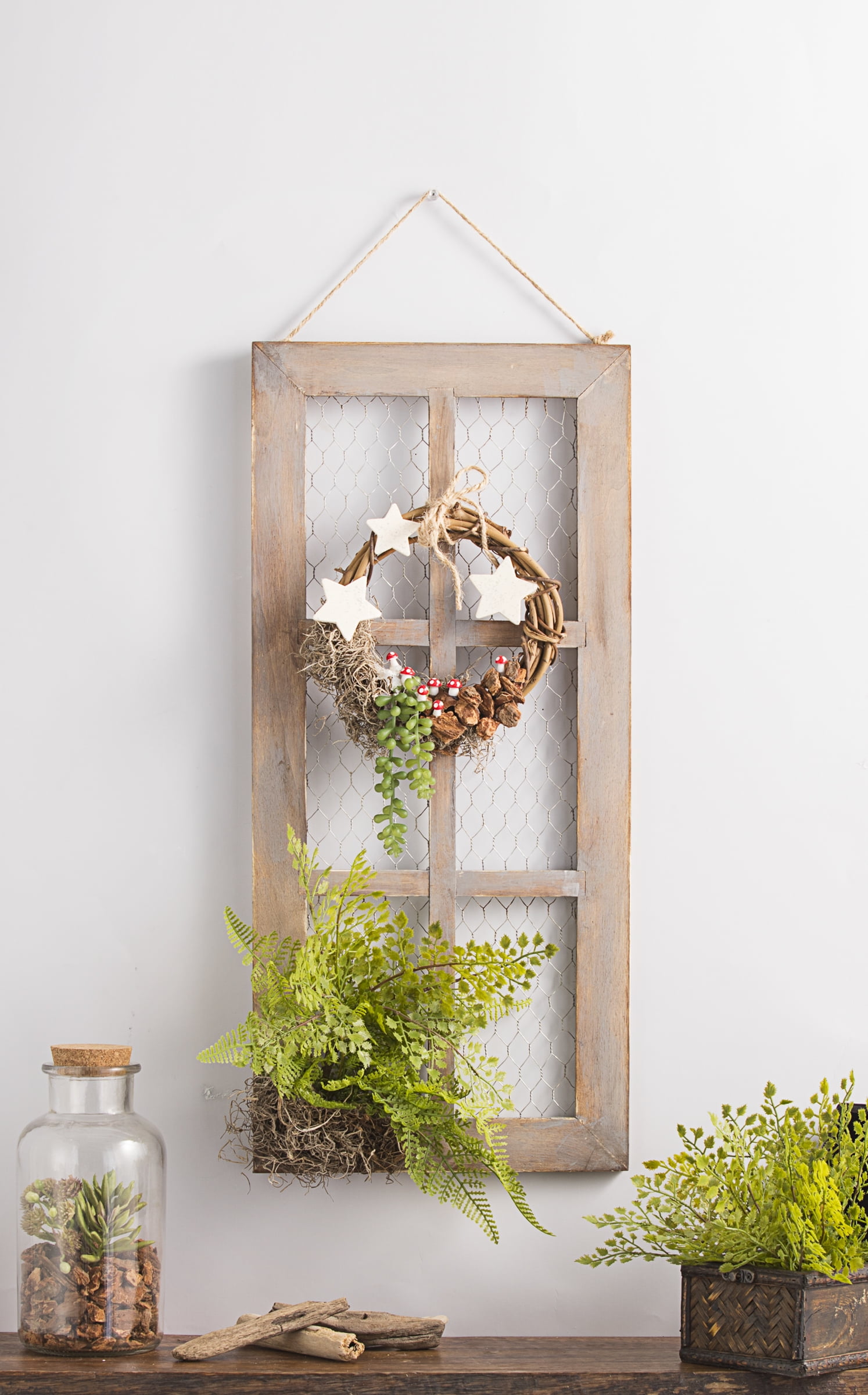 Wall art: old window frame, chicken wire, old bottles and greenery