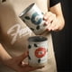 thumbnail image 5 of Taza de cerámica de gran capacidad con rayas azules y diseño retro de arte latte., 5 of 6
