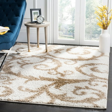 Safavieh New York Shag SG167H Indoor Area Rug Swirl nature-inspired patterns through your room with the Safavieh New York Shag SG167H Indoor Area Rug. This high-contrast shag rug feels cushions your feet and has an organic design of leafy scrollwork against a solid background.