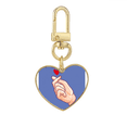thumbnail image 1 of Gestos de melocotón. Llavero de metal en forma de corazón dorado, 1 of 3