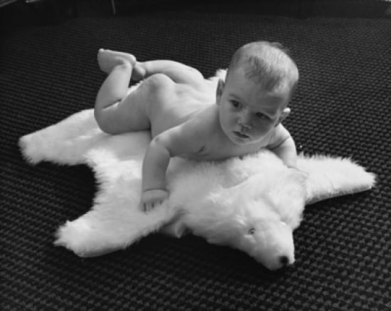 Baby Lying On A Bearskin Rug Poster Print Com