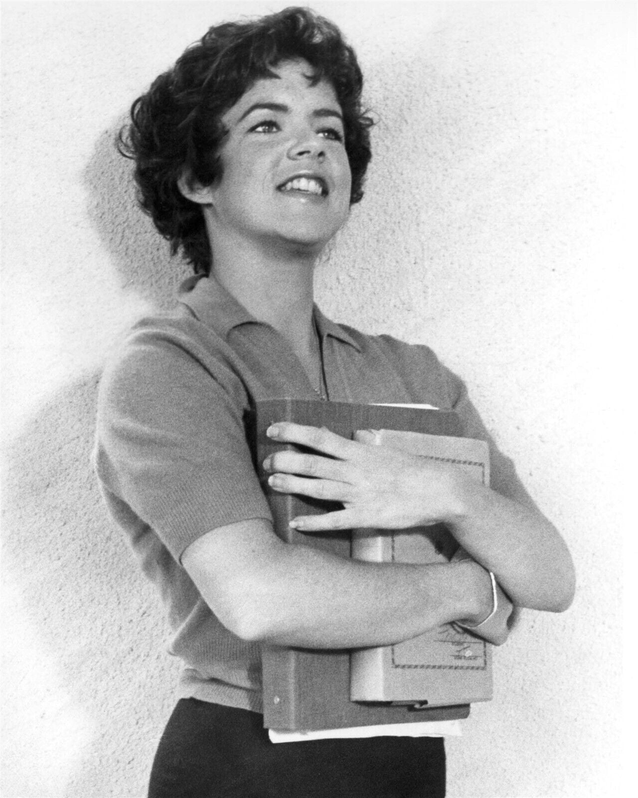 Stockard Channing smiling holding school books as Rizzo from Grease ...