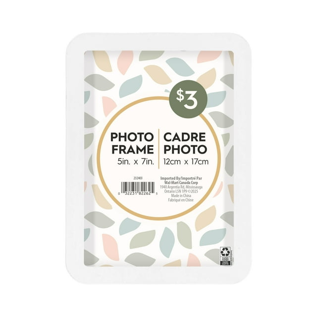 Rounded white tabletop picture frame with pastel leaf design border, fits 5 by 7 inch photos, priced at three dollars.