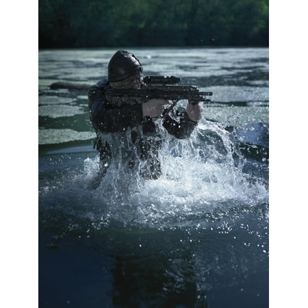 Special operations forces soldier emerges from water armed with a Steyr AUG assault rifle Poster