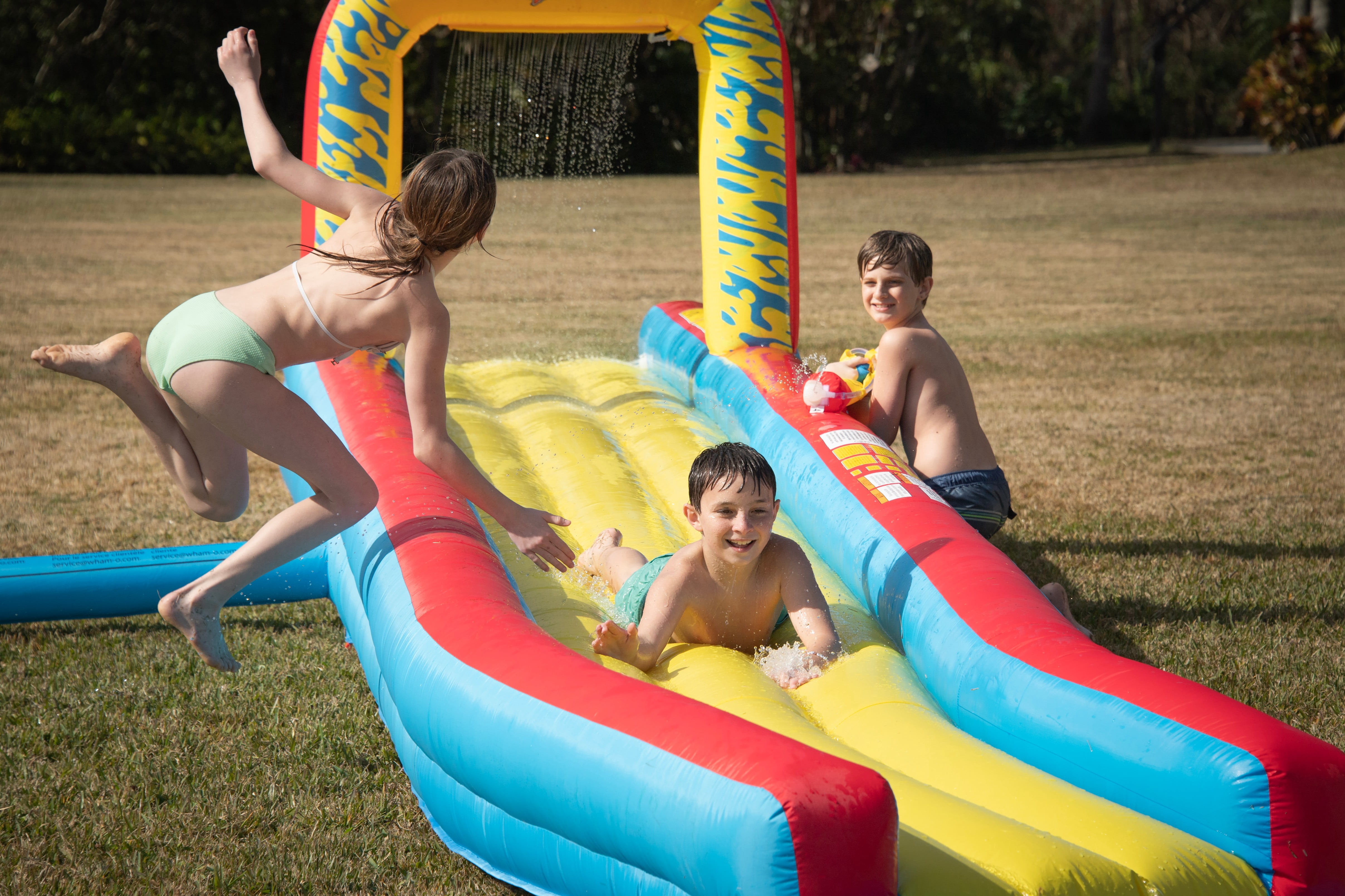 Wham-O 30-Foot Constant Air Slip N Slide Inflatable Water Slide with Blower, Air-Cushioned Track, Waterfall Splash, Water Cannon, Ages 5-12, 1-Count